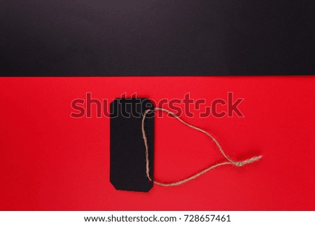 Black tags on a bright red background. The black background is empty.