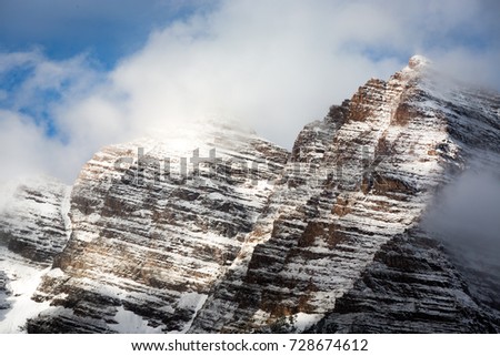 Close up of Maroon Peak with some snow covered against a cloudy sunny blue sky, Maroon Bells, Aspen, Colorado, USA.