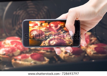 Photo on the social networking site of pastries. Woman photographing smartphone baked in the oven homemade casseroles.