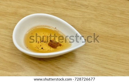 Pear Shape Cup White Color. In a Cup of Oil is Used Leftover from Cooking. This is one of the causes of cancer. Royalty-Free Stock Photo #728726677