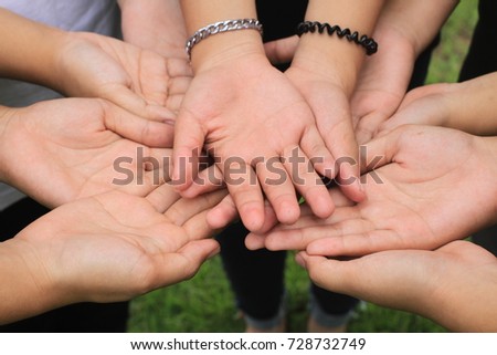 Female holding hand together , strong concept about teamwork and cooperation, also refers to immigration and friendship.