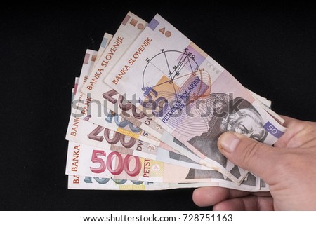 some old Slovenian Taller banknotes on the hand
