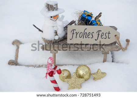 Snowman with sledge in the snow, (frohes fest = happy holyday