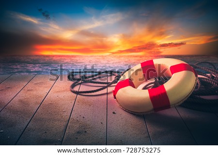 life saver on a dock at the beach on a sunny day Royalty-Free Stock Photo #728753275