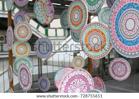 many colorful lines art on circle papers hanging around the curtain.,beautiful lines abstract art background