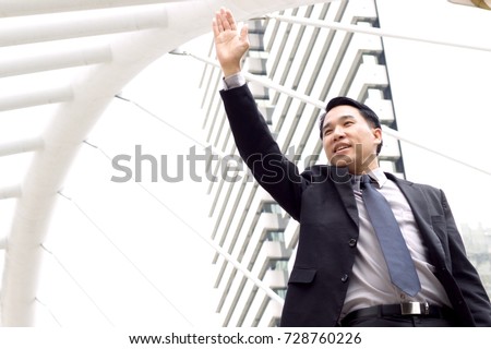 Asian businessman gesture of greeting say hello or goodbye in the city