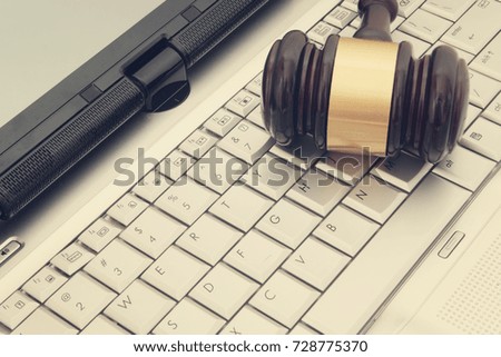 Judge gavel on silver laptop computer, cyber law or crime concept