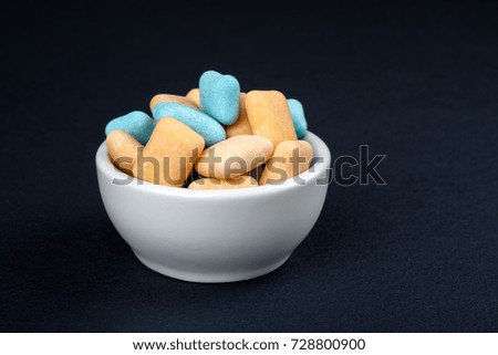 Colored chewing gum in a white bowl