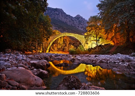 PYLI BRIDGE, TRIKALA, GREECE.
Pyli old stone arched bridge, also know as "Porta Panagia" bridge, close to Pyli town, Trikala, Thessaly, Greece  Royalty-Free Stock Photo #728803606