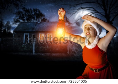 santa claus woman with lamp and dark background of night and moon on sky 