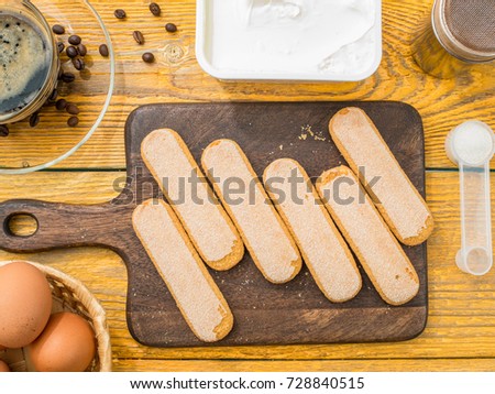 Photo on top of cookie on cutting board, eggs, cream cheese, coffee, grains