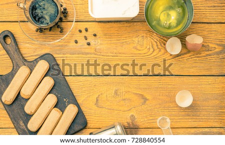Picture on top of table with savoyardi cookies, coffee, cream cheese. Place for text