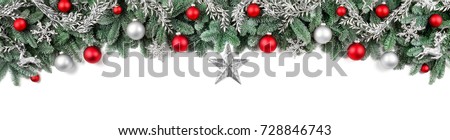 Wide arch-shaped Christmas border isolated on white, composed of fresh fir branches and ornaments in red and silver