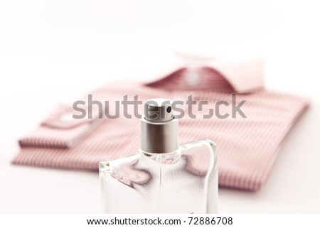 Stylish image of a bottle of scent an a nice man's shirt