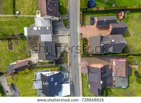 Aerial photo with the drone, a new build-up plot with single houses and gardens, narrow neighborhood