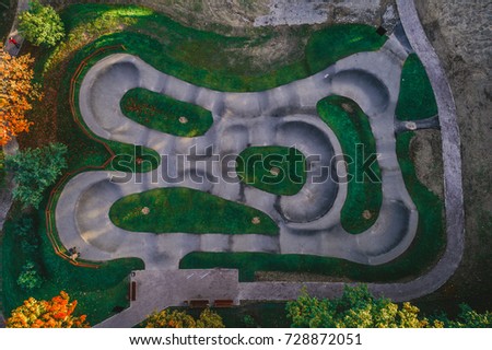 Aerial view on asphalted bicycle race track, pump track, kids playground