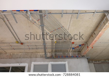 electric lines power and label on the wall under cement ceiling of construction house building