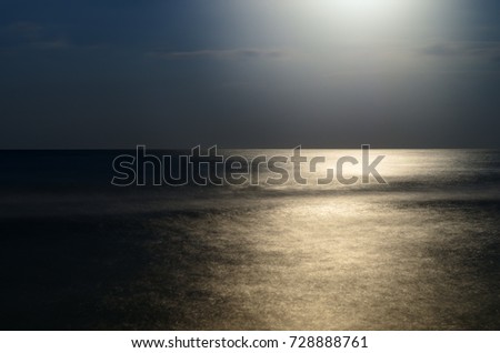 moonlight at night over the sea, reflection. horizon blue sky with clouds. a picture on a long time. Beautiful landscape.