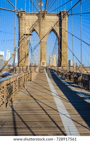 Almost nobody on the Brooklyn Bridge just after sunrise in New York, USA