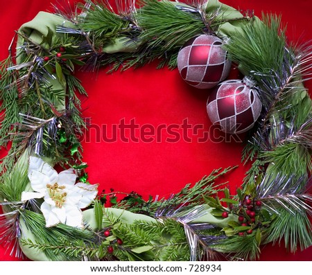 empty christmas frame on red background with poinsettia holly and red ornaments