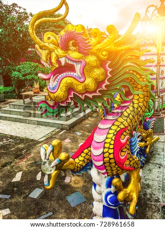 Low angle view of the statue of the dragon with bright sun.