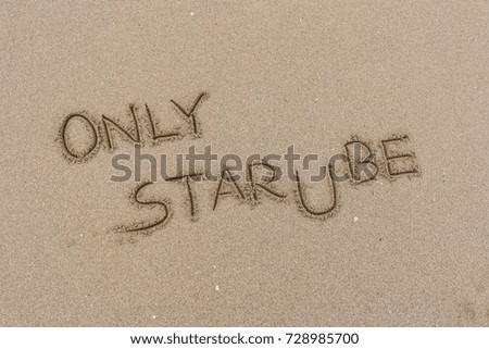 Handwriting  words "ONLY STAR U BE" on sand of beach.