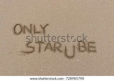 Handwriting  words "ONLY STAR U BE" on sand of beach.