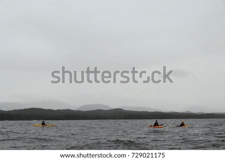 Small group of kayakers paddling in Foggy Bay, Alaska, USA Royalty-Free Stock Photo #729021175