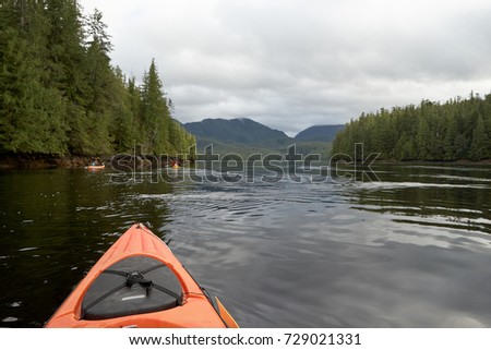 Kayaking in Foggy Bay Ketchican, Alaska from a first person POV looking out over ca,l water and evergreen forests Royalty-Free Stock Photo #729021331