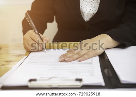 Close up business woman reaching out sheet with contract agreement proposing to sign.Full and accurate details, individual who owns the business sign personally,director of the company, solicitor.
