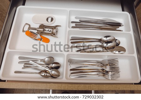 A set of different cutlery. Box with spoons, forks, knives