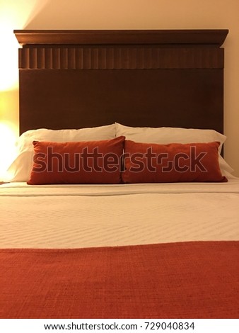 A bed with pillows inviting to rest