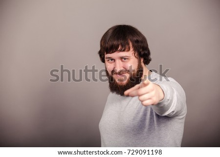 Businessman pointing left hand not straight forward on dark background