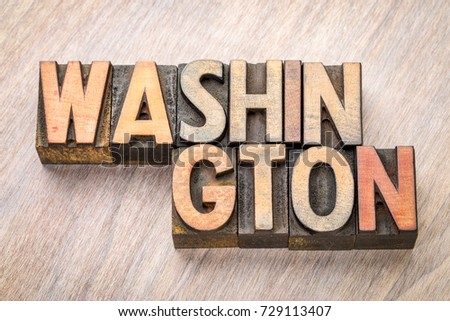 Washington word abstract in vintage letterpress wood type printing blocks against grained wooden background