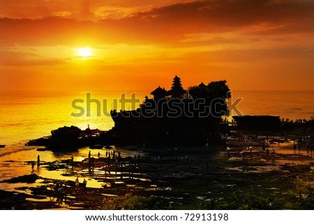 Tanah Lot in golden sunset, Bali, Indonesia.Silhouette of Tanah Lot  temple the most attraction and travel destination of bali. Tanah Lot is Hindu temple, one of seven  temple around Balinese coast.