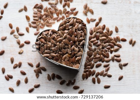 Whole Brown Flaxseeds in a Heart Shape Royalty-Free Stock Photo #729137206