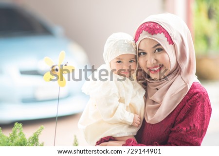 Muslim Indonesian family mom and child concept. Young Asian Muslim Mother and her daughter child girl smiling and hugging together Royalty-Free Stock Photo #729144901