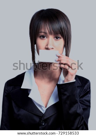 Girl holding empty business card in front of her mouth