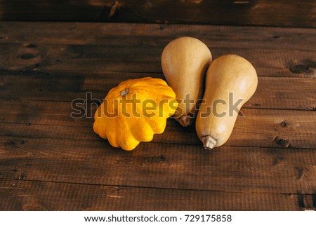 Autumn harvest. Pumpkin and squash on a wooden background. toning
