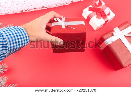 Beautiful gift boxes with a red and white bow on a red background.