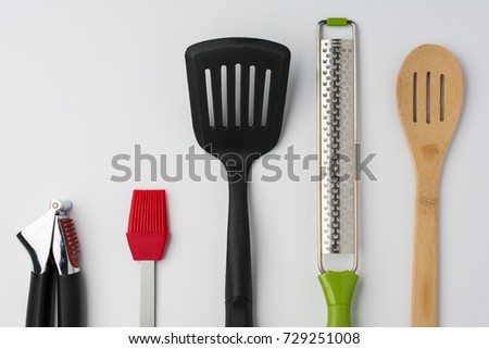Garlic Press Brush Spoon Spatula Zester on White Background Cropped Close