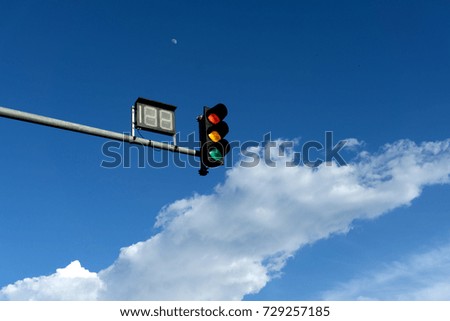 traffic light with blue sky and clouds at background