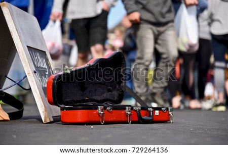 Violin case opens for donating money and coins on street, Buskers performing arts in public for money.