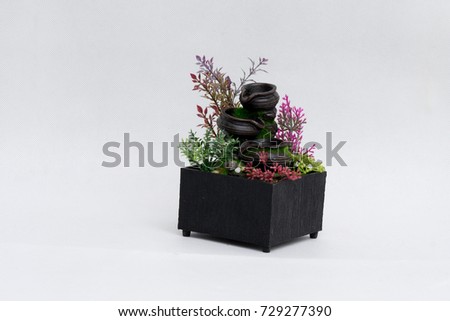 Plastic flower in Wooden pots with waterfalls