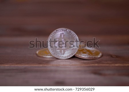 Bitcoins on a wooden background. A concept from coins of the cryptocurrency.