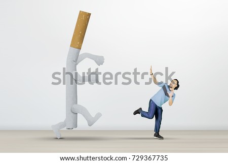 Picture of African man chased by a cigarette while running in the studio, isolated on white background