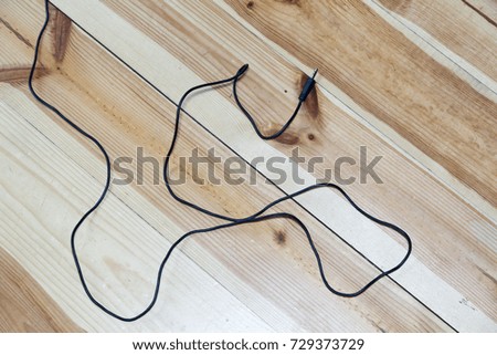 lavalier microphone on wooden laminate obtained