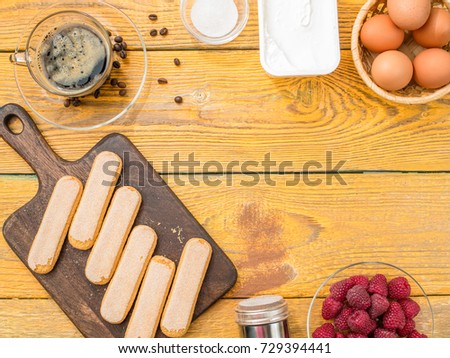 Photo on top of table with biscuits, eggs, raspberries, creamy cream