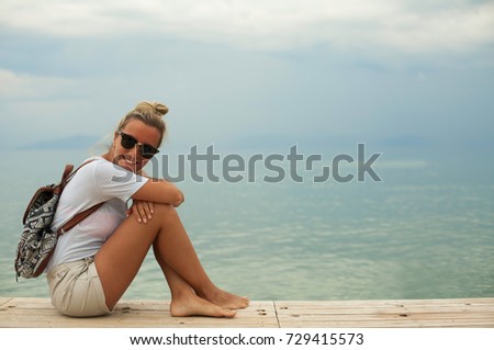 Young woman sitting and relaxing on the seaside