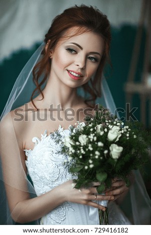 Model is posing in the interior studio in a wedding dress